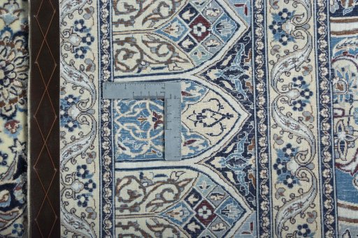 Backside of handmade New Nain rug showing knot structure and weave density
