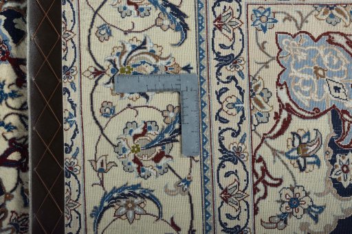 Backside of handmade New Nain rug showing knot structure and weave density