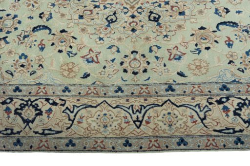 Corner detail of 2000s Nain rug showing border pattern and Wool pile