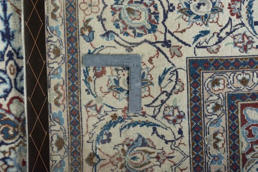 Backside of handmade New Nain rug showing knot structure and weave density