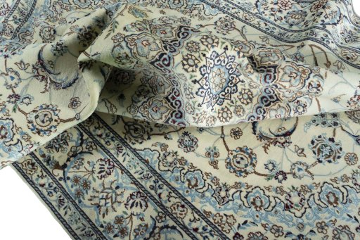 Surface texture of 2000s Nain rug with natural Wool and intricate pattern