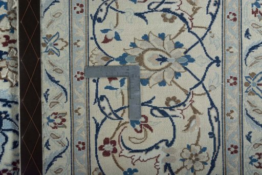 Backside of handmade New Nain rug showing knot structure and weave density