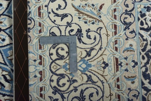 Backside of handmade 2000s Nain rug showing knot structure and weave density