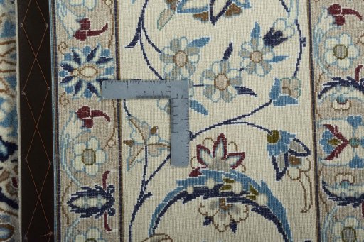 Backside of handmade New Nain rug showing knot structure and weave density