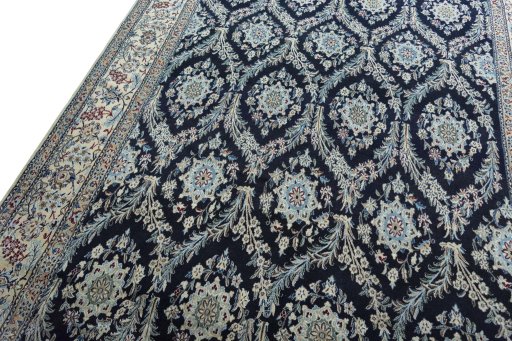 Backside of handmade New Nain rug showing knot structure and weave density