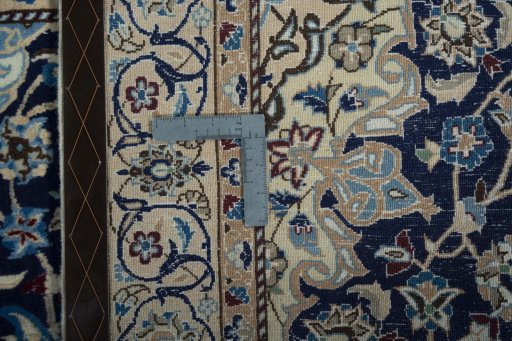 Backside of handmade 2000s Nain rug showing knot structure and weave density