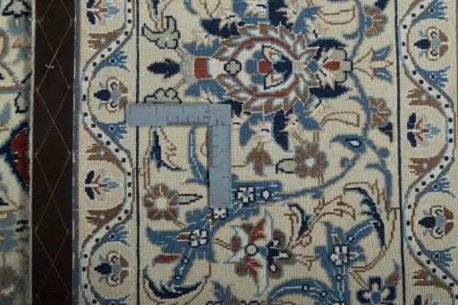 Backside of handmade 2000s Nain rug showing knot structure and weave density