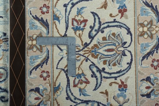 Backside of handmade 2000s Nain rug showing knot structure and weave density
