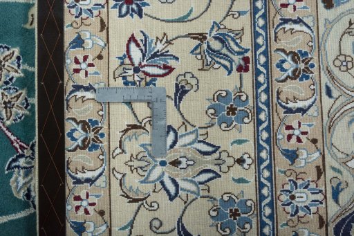 Backside of handmade 1970s Nain rug showing knot structure and weave density