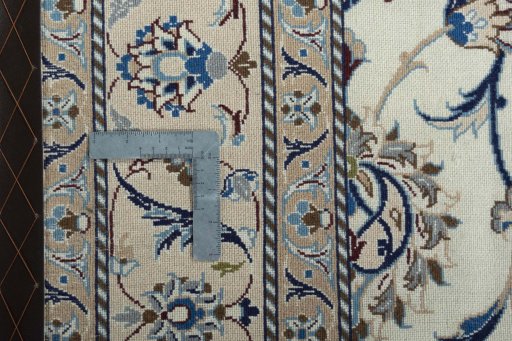 Surface texture of 1970s Nain rug with natural Wool and intricate pattern