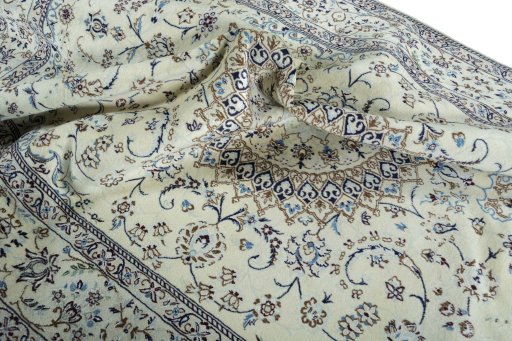 Surface texture of 2000s Nain rug with natural Wool and intricate pattern
