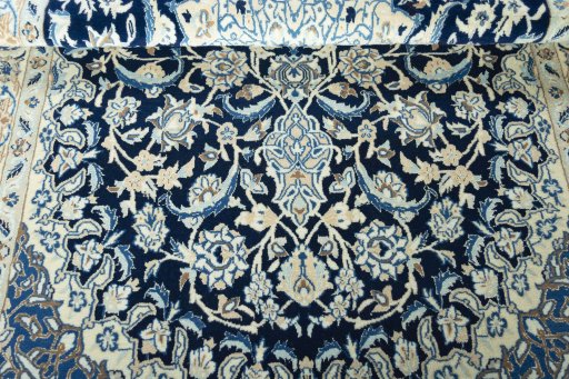 Corner detail of 2000s Nain rug showing border pattern and Wool pile