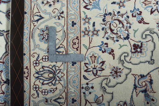 Backside of handmade New Nain rug showing knot structure and weave density