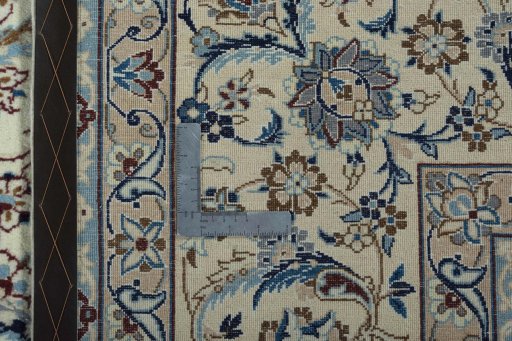 Backside of handmade New Nain rug showing knot structure and weave density