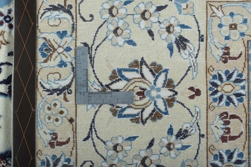 Backside of handmade New Nain rug showing knot structure and weave density