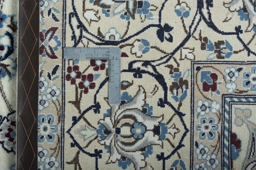 Backside of handmade New Nain rug showing knot structure and weave density