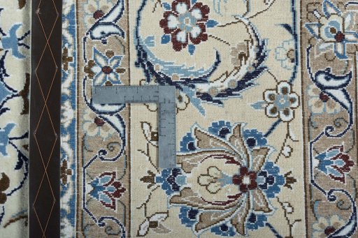 Backside of handmade New Nain rug showing knot structure and weave density