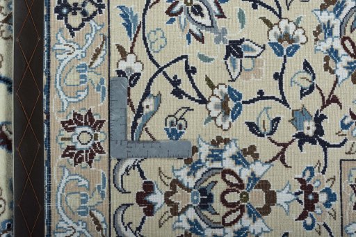 Backside of handmade 2000s Nain rug showing knot structure and weave density