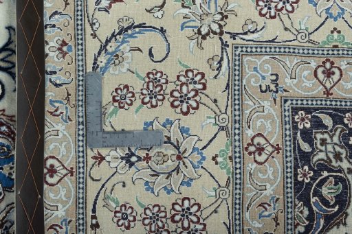 Backside of handmade New Nain rug showing knot structure and weave density