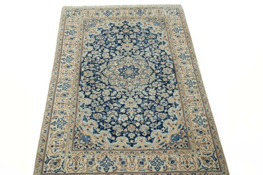 Surface texture of 2000s Nain rug with natural Wool and intricate pattern