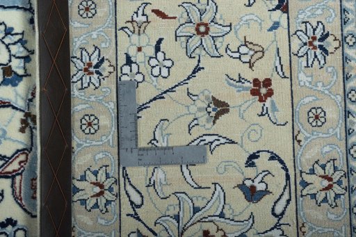Backside of handmade New Nain rug showing knot structure and weave density