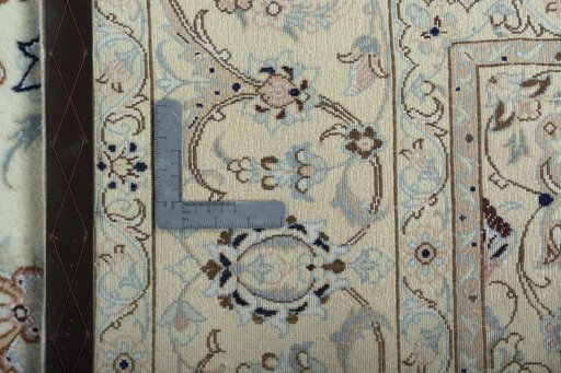 Backside of handmade New Nain rug showing knot structure and weave density