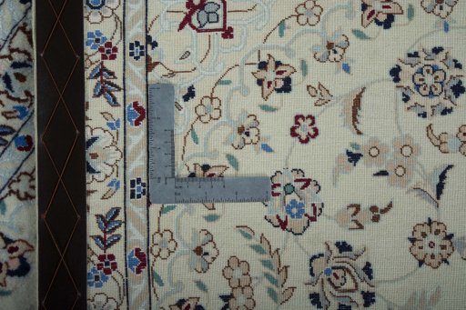 Backside of handmade New Nain rug showing knot structure and weave density