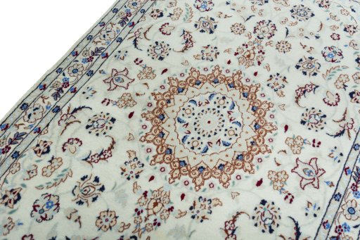 Backside of handmade New Nain rug showing knot structure and weave density