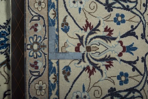 Backside of handmade New Nain rug showing knot structure and weave density