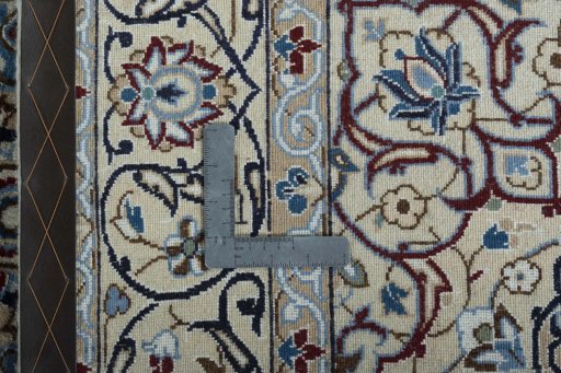 Backside of handmade New Nain rug showing knot structure and weave density