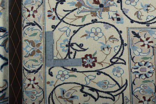 Backside of handmade New Nain rug showing knot structure and weave density