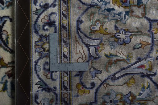 Backside of handmade New Nain rug showing knot structure and weave density