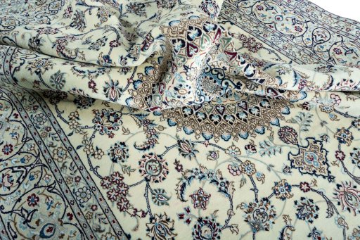 Surface texture of 2000s Nain rug with natural Wool and intricate pattern