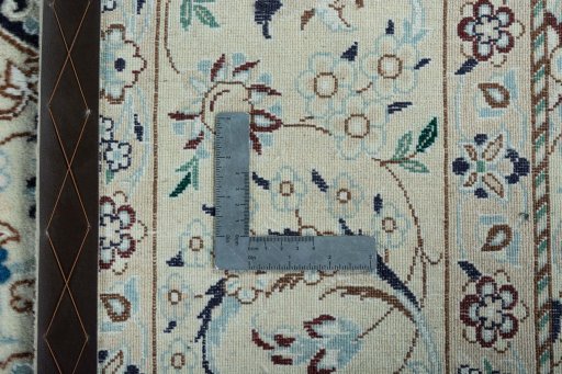 Backside of handmade New Nain rug showing knot structure and weave density