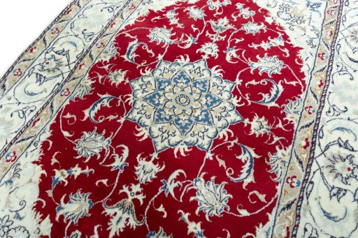 Backside of handmade New Nain rug showing knot structure and weave density