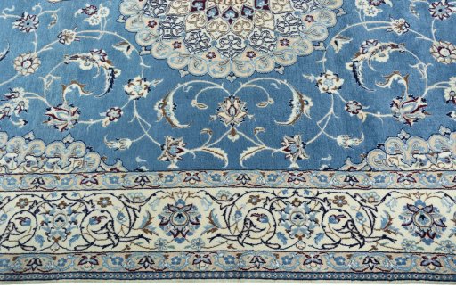 Corner detail of 2000s Nain rug showing border pattern and Wool pile