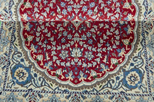 Corner detail of 2000s Nain rug showing border pattern and Wool pile