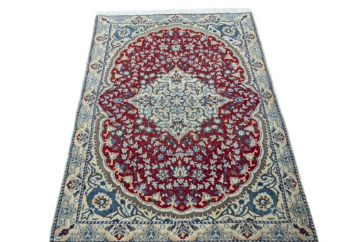 Surface texture of 2000s Nain rug with natural Wool and intricate pattern