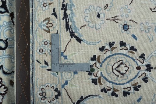 Backside of handmade New Nain rug showing knot structure and weave density