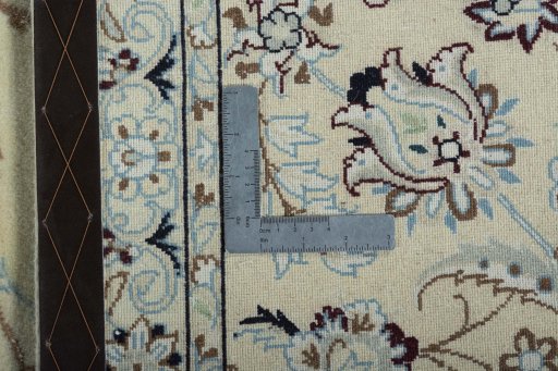 Backside of handmade New Nain rug showing knot structure and weave density