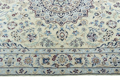 Corner detail of 2000s Nain rug showing border pattern and Wool pile