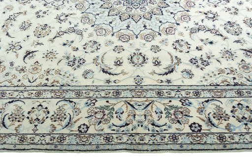 Corner detail of 2000s Nain rug showing border pattern and Wool pile