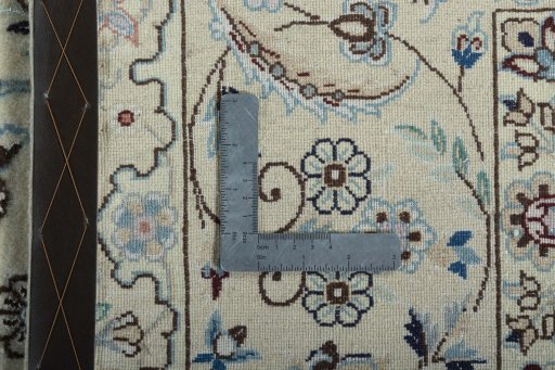 Backside of handmade New Nain rug showing knot structure and weave density