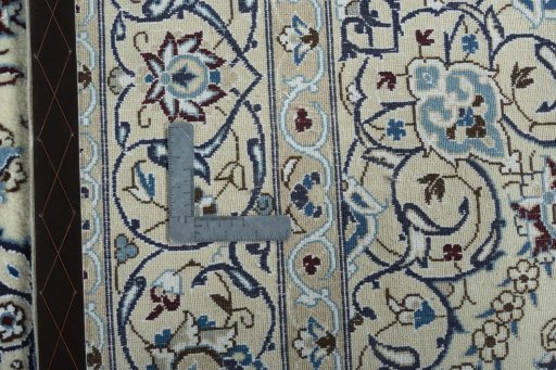 Backside of handmade 2000s Nain rug showing knot structure and weave density