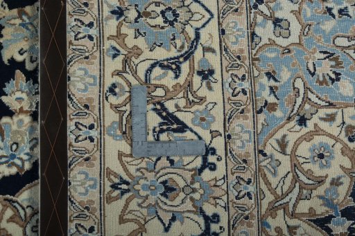 Backside of handmade New Nain rug showing knot structure and weave density