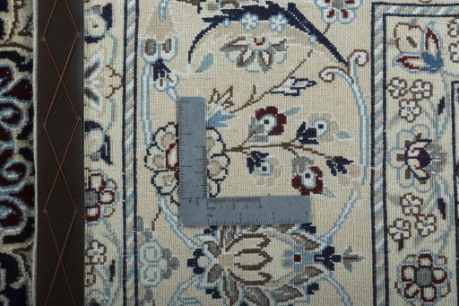 Backside of handmade New Nain rug showing knot structure and weave density