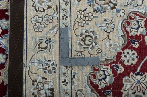 Backside of handmade New Nain rug showing knot structure and weave density