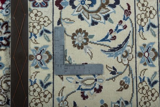 Backside of handmade 2000s Nain rug showing knot structure and weave density