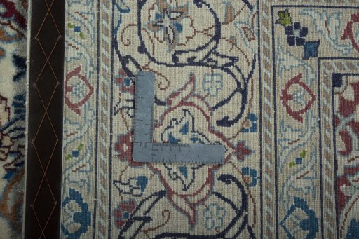 Surface texture of 2000s Nain rug with natural Wool and intricate pattern