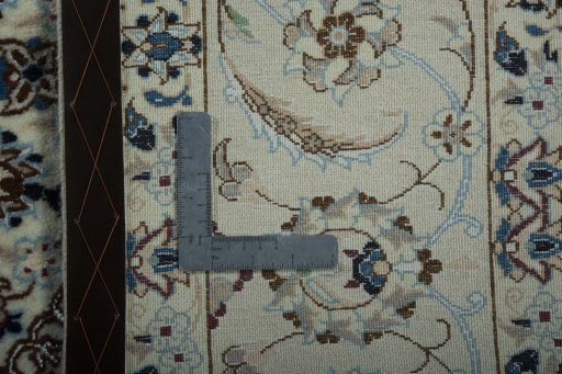 Backside of handmade New Nain rug showing knot structure and weave density